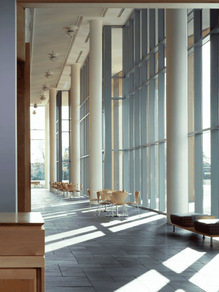 Bright modern interior with floor-to-ceiling windows and stylish seating for corporate or conference events.