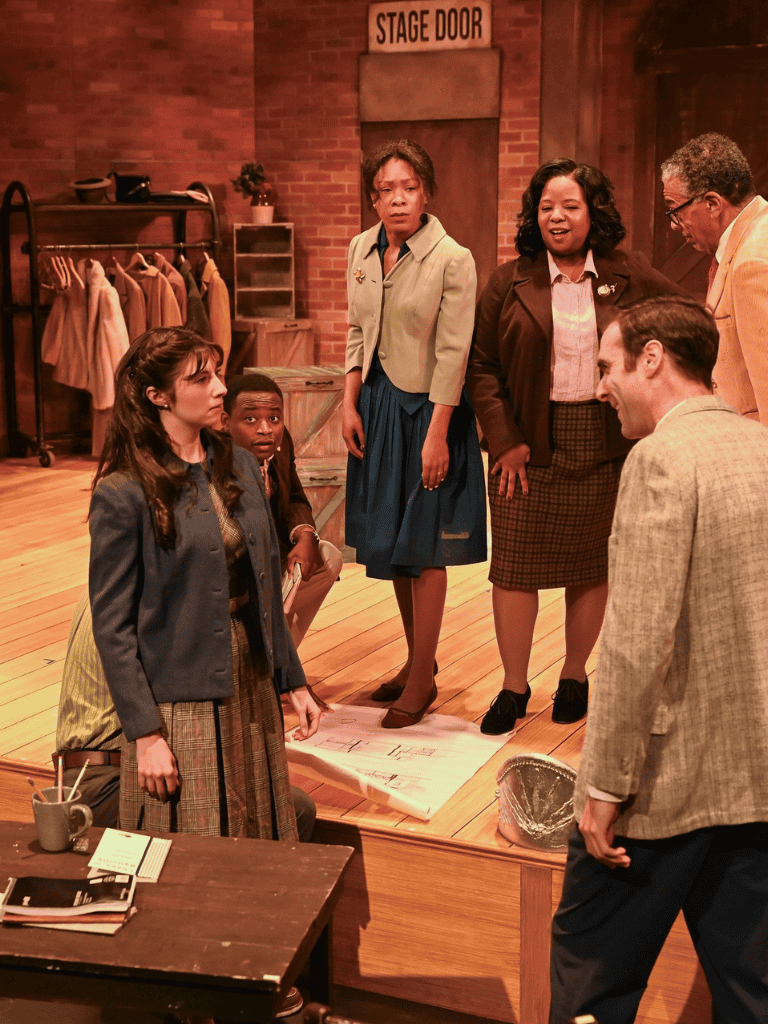 Clowning scene from QuestForDirections theatrical play showcasing diverse cast and stage set.