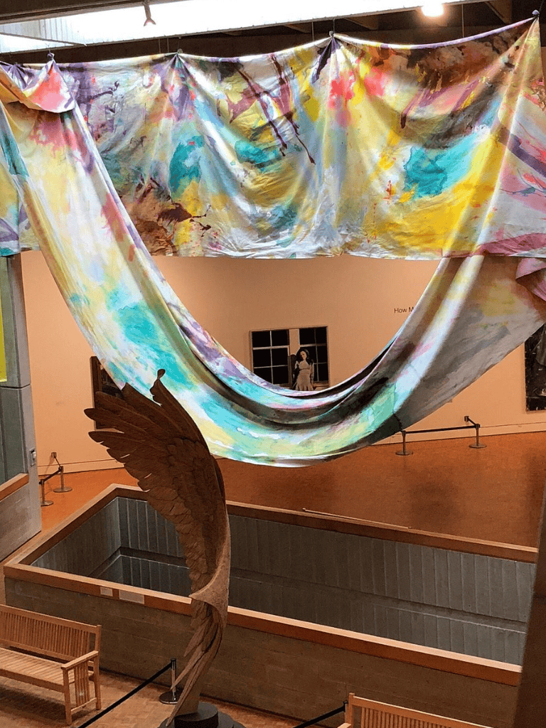 Colorful abstract fabric art installation at QuestForDirections gallery indoor exhibit.