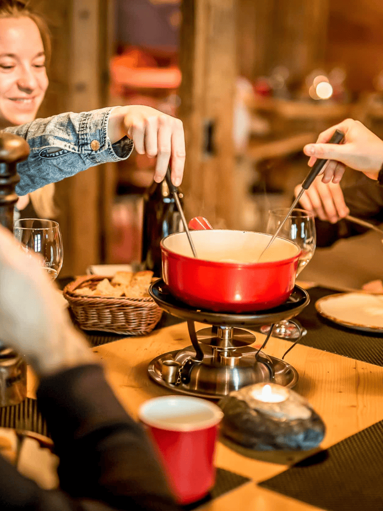 Cheese fondue dinner with friends at cozy rustic restaurant.