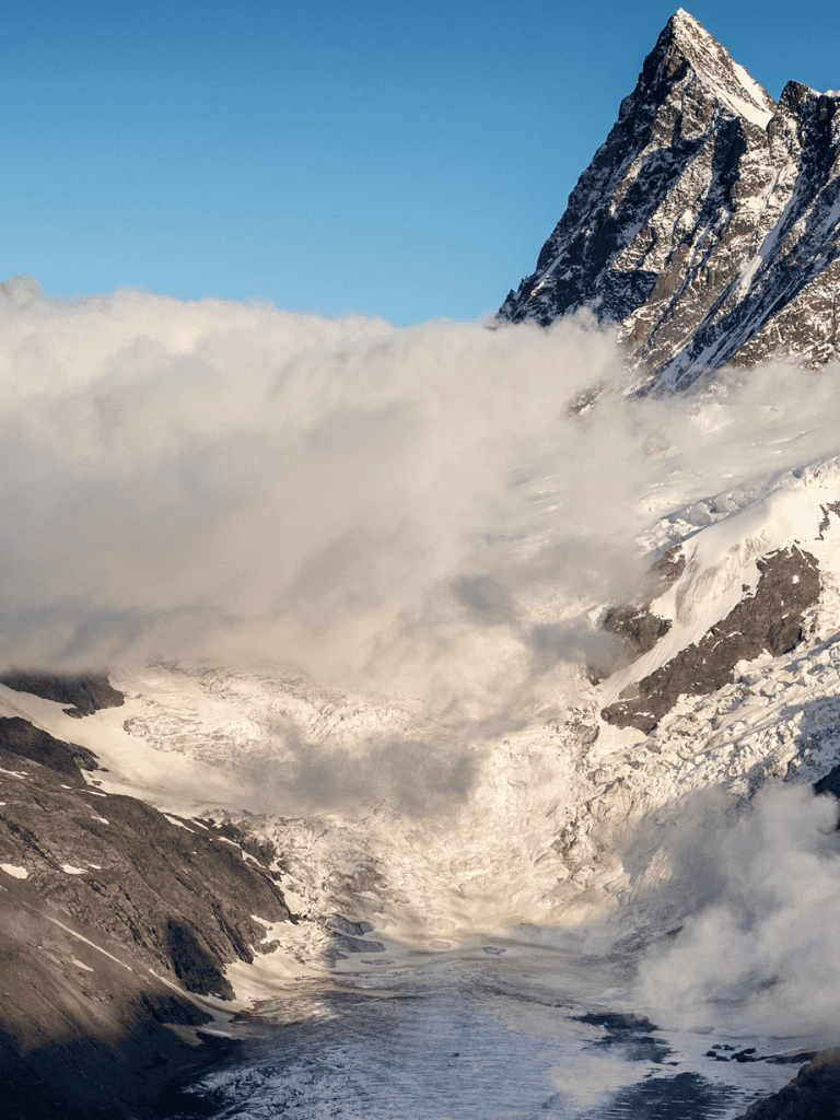 Majestic snow-capped mountain and glacier landscape with clouds, exploring mountain navigation and adventure.