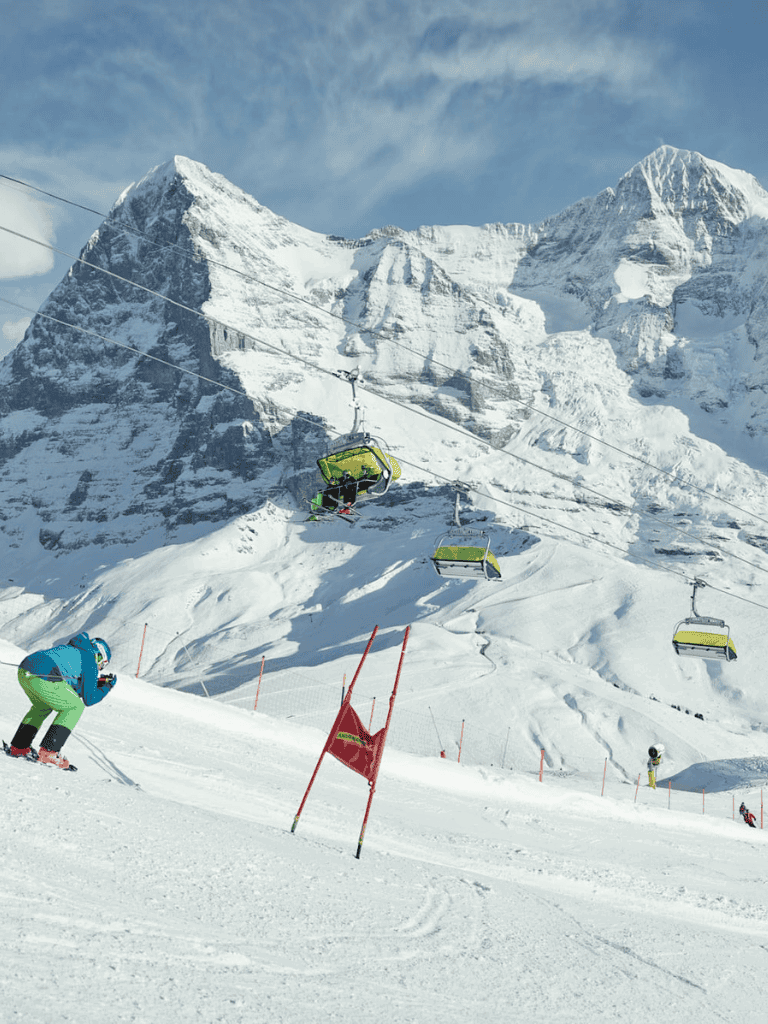 Skiers riding lifts in snowy mountains during daytime at QuestForDirections.