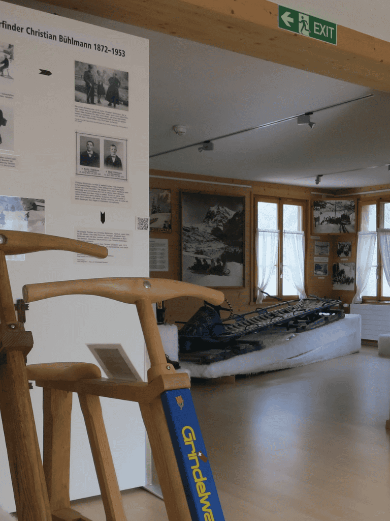 Old wooden sled display at outdoor museum or exhibit, showcasing Scandinavian heritage and winter sports history.