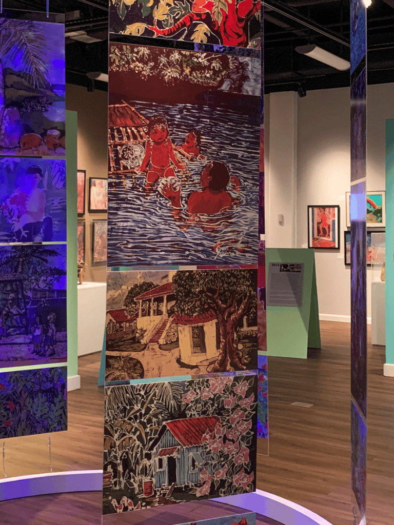 Colorful outdoor and rural art murals displayed at QuestForDirections art exhibit, highlighting vibrant community and landscape scenes.