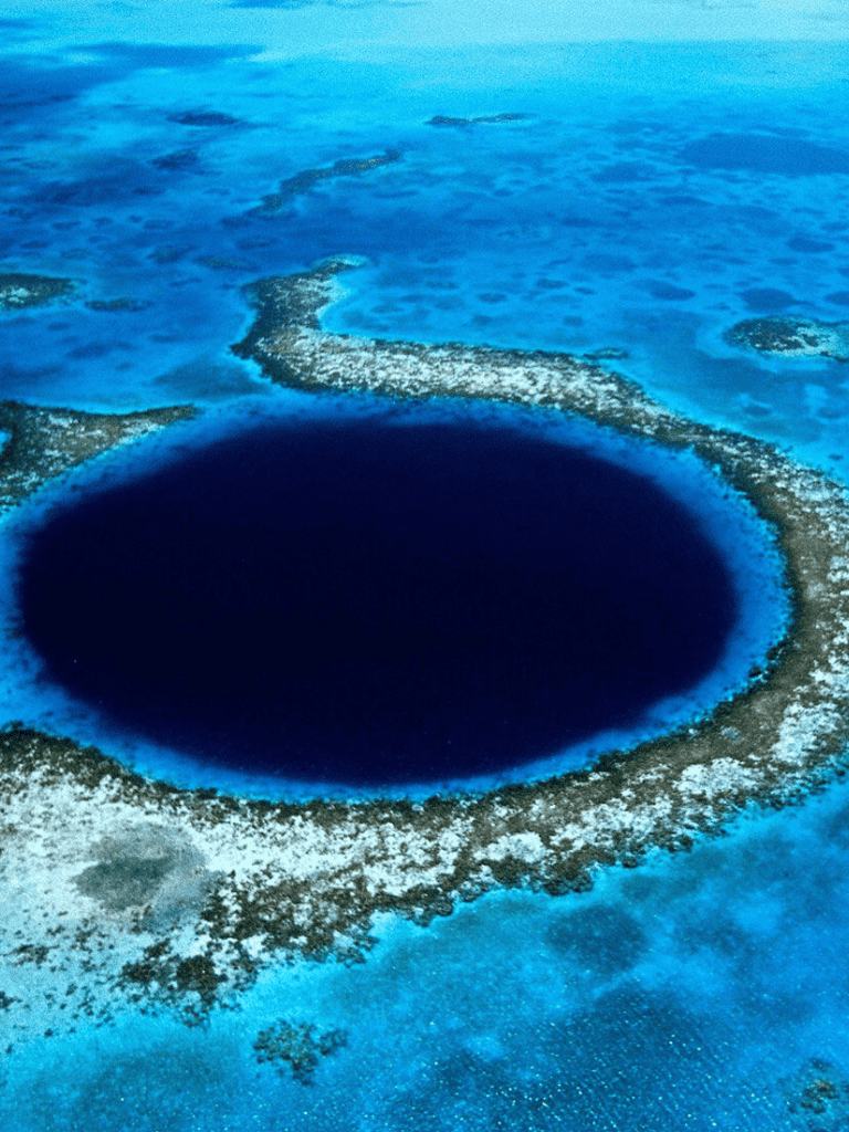 Vortex deep blue hole in ocean, famous undersea sinkhole, black circle, marine exploration, adventure travel, QuestForDirections.