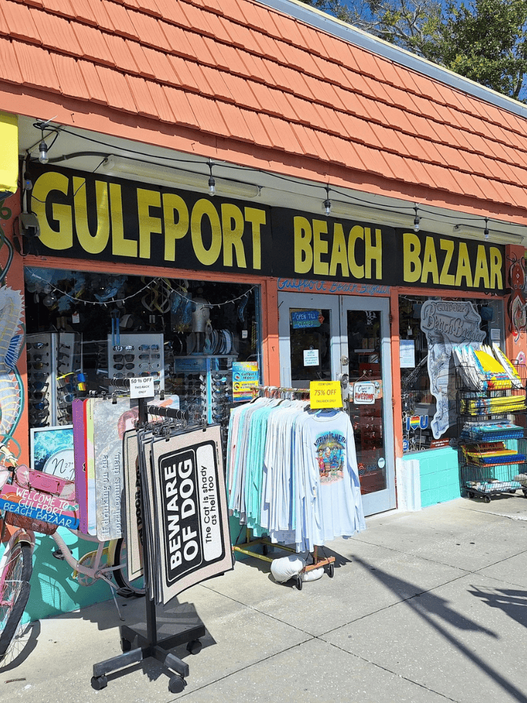 Bright sign for Gulfport Beach Bazaar offers beach souvenirs, apparel, and accessories.