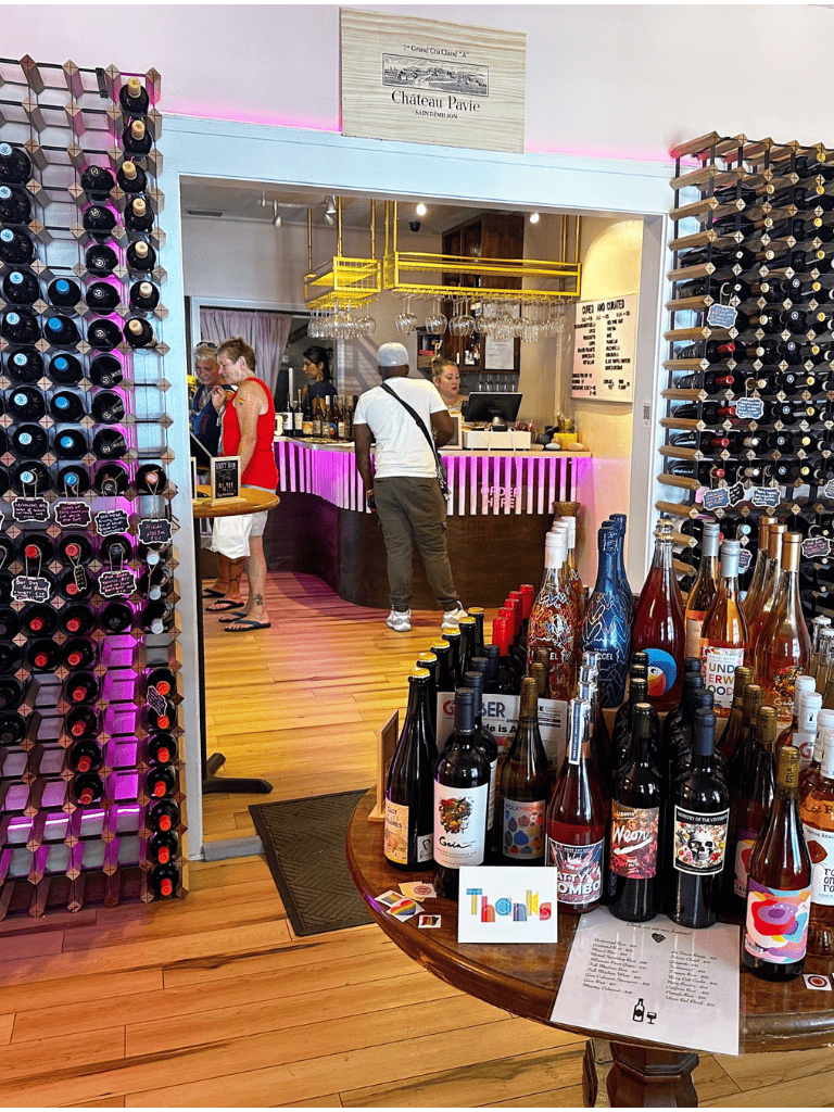 Colorful wine bottles display at QuestForDirections wine shop with vibrant interior and modern decor.