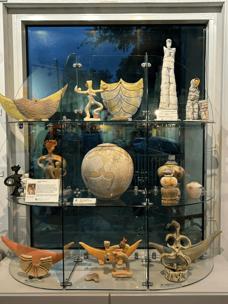 Colorful ancient pottery art sculptures display at QuestForDirections museum exhibit.