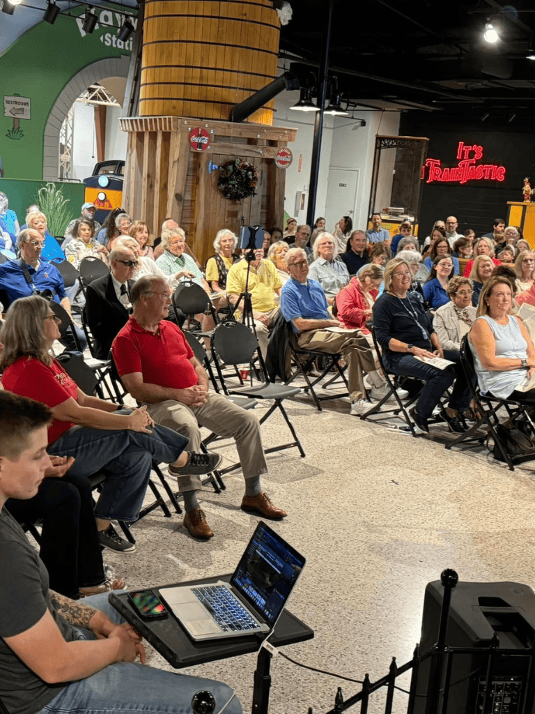 Networking event at QuestForDirections, attendance by diverse audience, engaging presentations in a vibrant space.