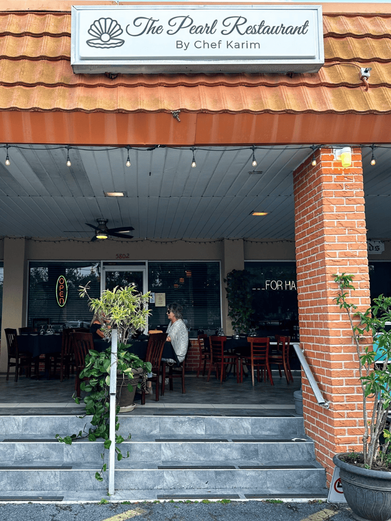 Outdoor dining at The Pearl Restaurant on QuestForDirections. Enjoy seafood and chef specials in a cozy setting.