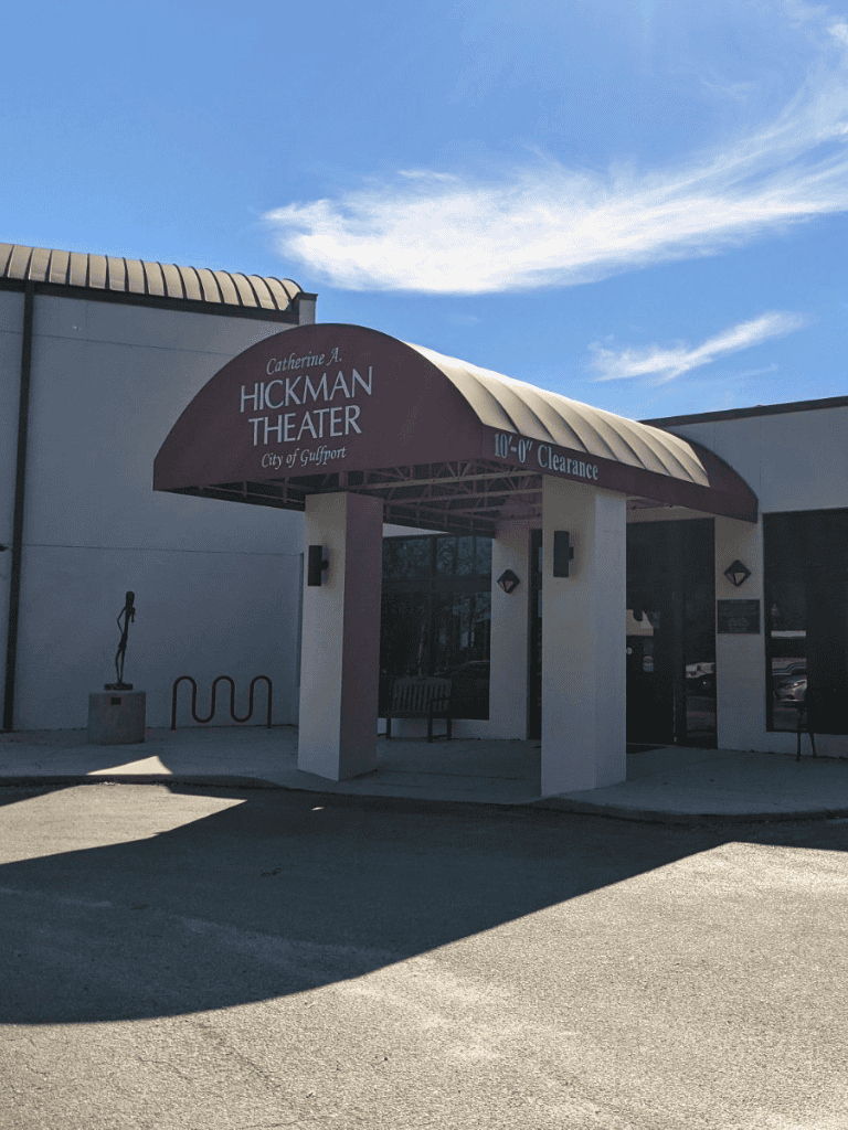 Accessible entrance sign at Hickman Theater in Gulfport with clear 10-foot clearance indication.