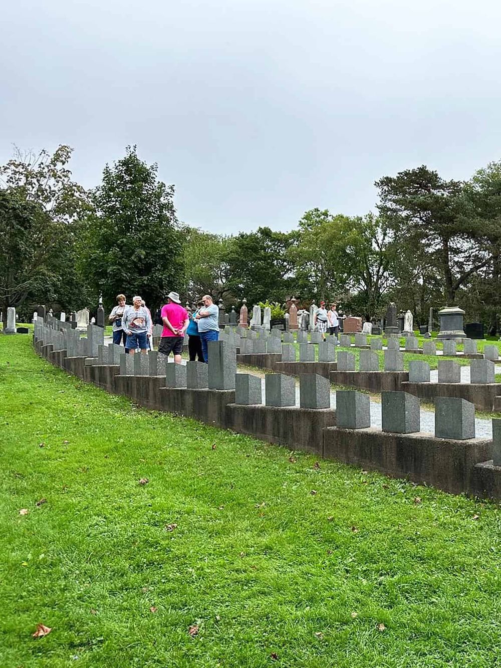 Graveyard tour with visitors exploring historic cemetery, guided by QuestForDirections.