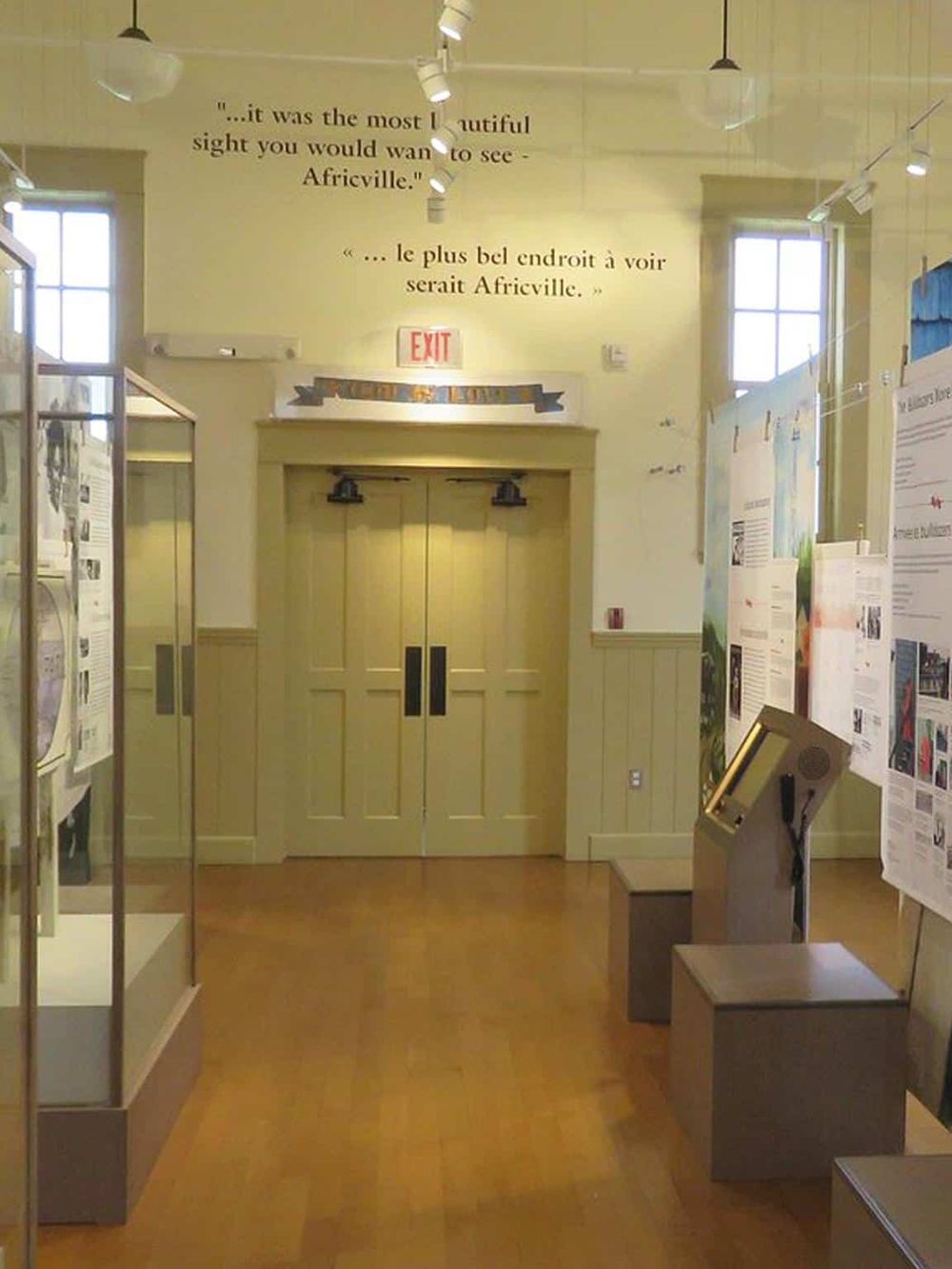 Old town exhibit at Quest for Directions museum, featuring historical displays and informational posters.