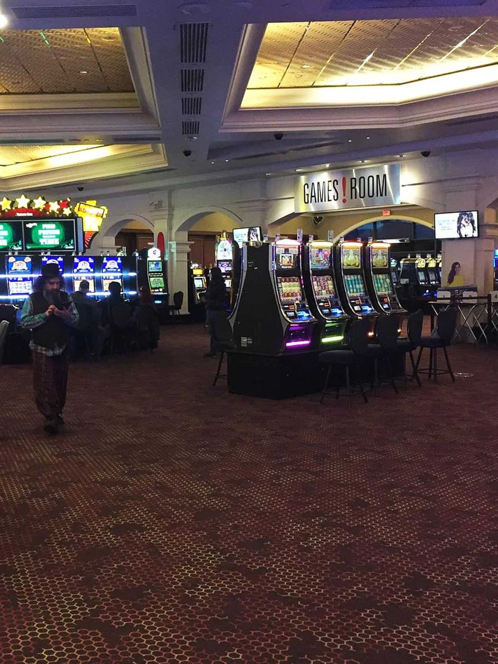 Bright casino gaming machines at QuestForDirections, featuring slot machines and gaming room ambiance.