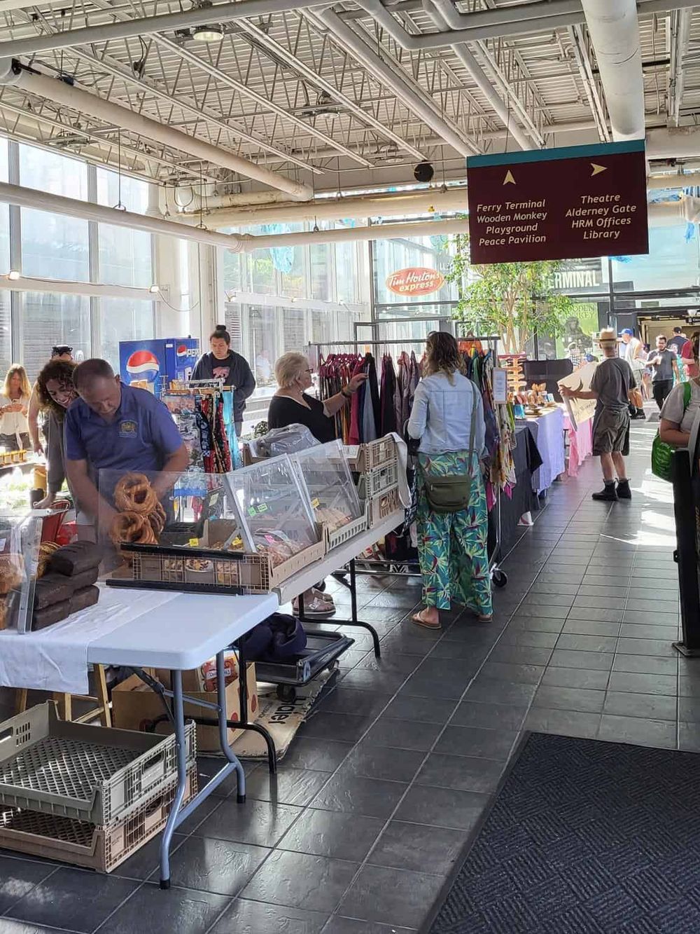 Colorful marketplace at Mission Valley Transit Center, featuring a variety of food vendors and craft stalls.