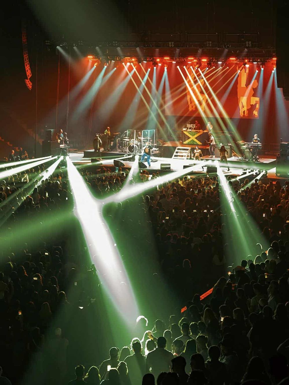 Vibrant concert stage with dynamic lighting and energetic crowd at QuestForDirections event.