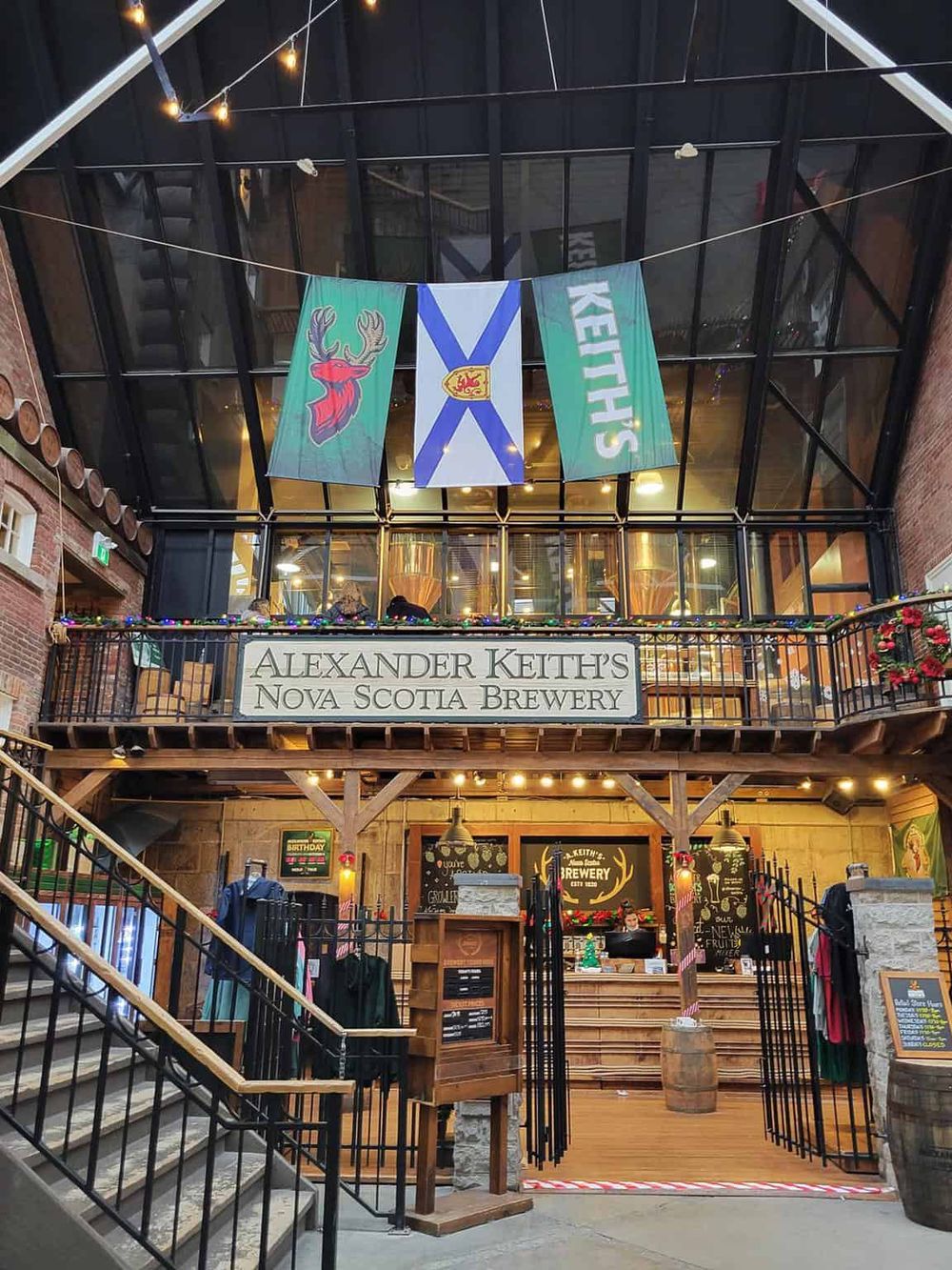 Vibrant indoor brewery at Alexander Keith's Nova Scotia Brewery with Scottish flags, cozy ambiance, and decorative elements.