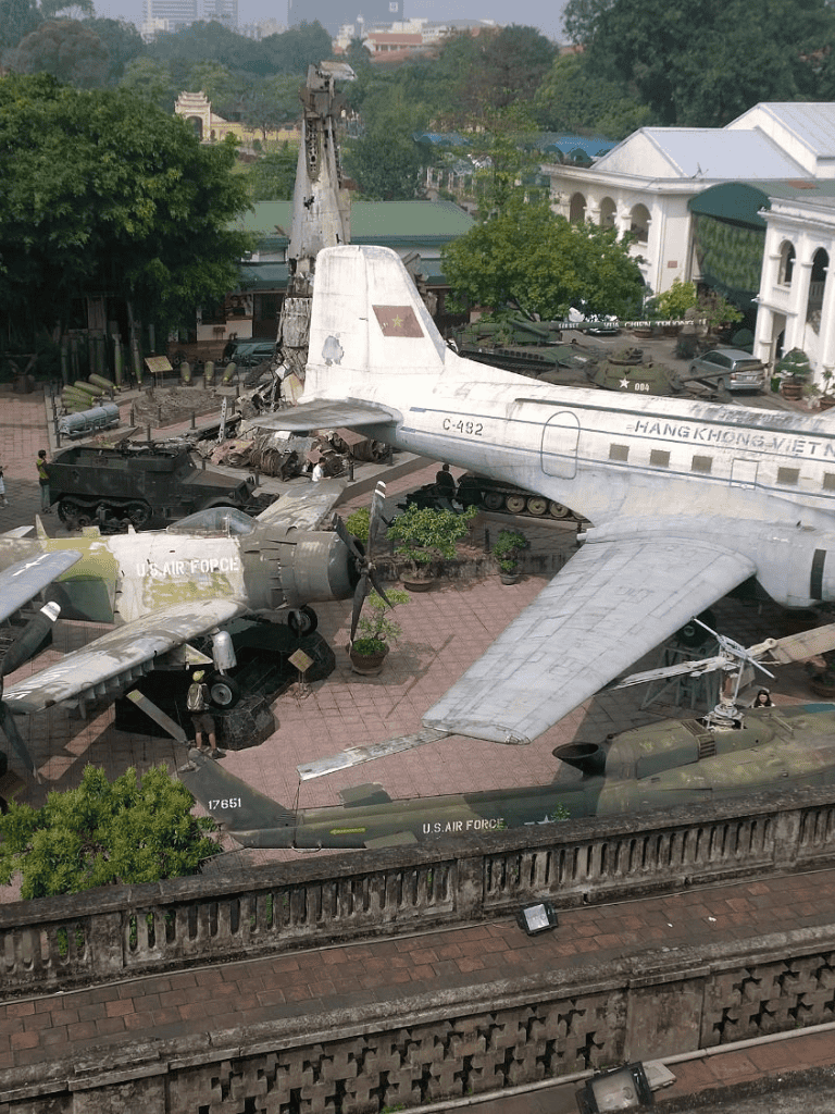 Aircraft exhibit at Vietnam Military Museum in Hanoi, showcasing U.S. military planes and helicopters.