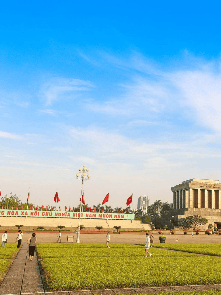 Vietnamese historical monument with flags and open plaza, ideal for sightseeing and cultural tours.