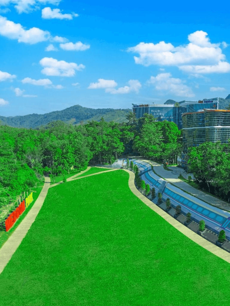 Vibrant green park with walking paths and surrounding trees near QuestForDirections location.