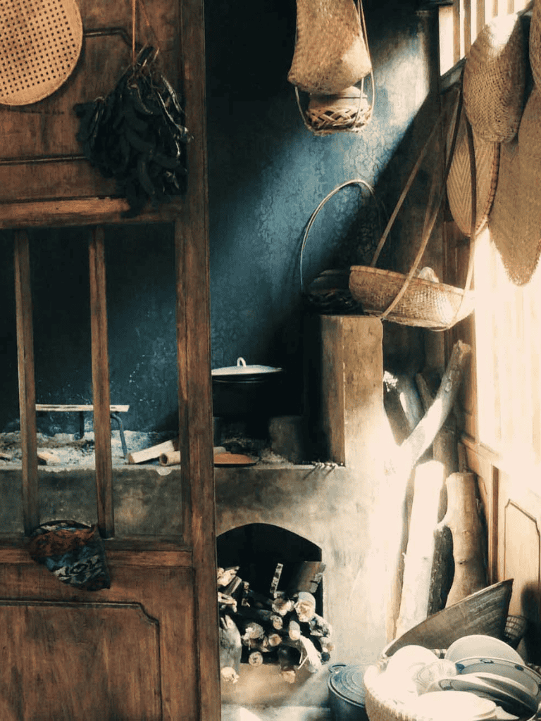 Cozy rustic kitchen with wooden accents and natural sunlight, perfect for traditional cooking and homey atmosphere.