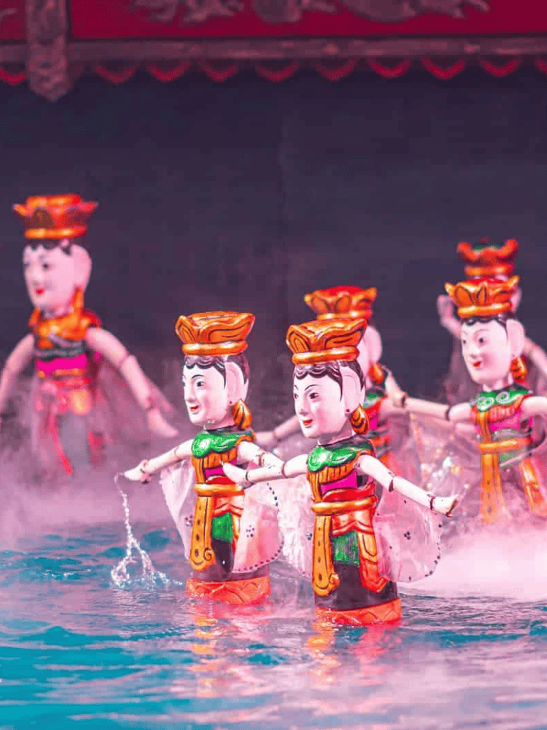 Colorful traditional puppet dance performance with vibrant costumes and water splash effects.