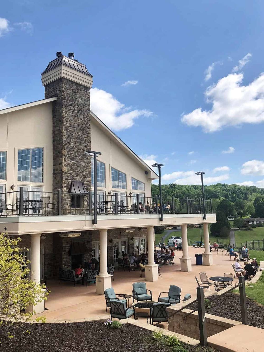 Outdoor dining and scenic views at QuestForDirections restaurant in a picturesque countryside setting with a spacious patio.