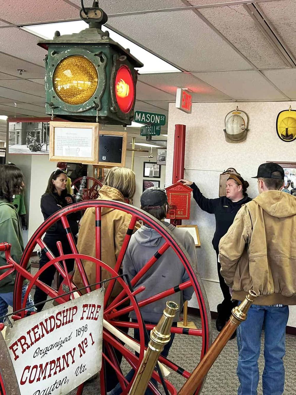 Antique fire alarm bell and historical firefighting equipment showcase at a fire museum.