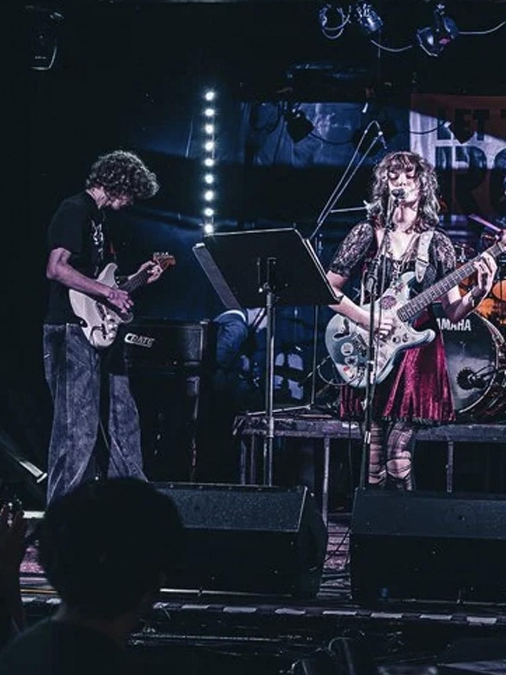 Live music performance at QuestForDirections concert venue, showcasing talented musicians on stage.