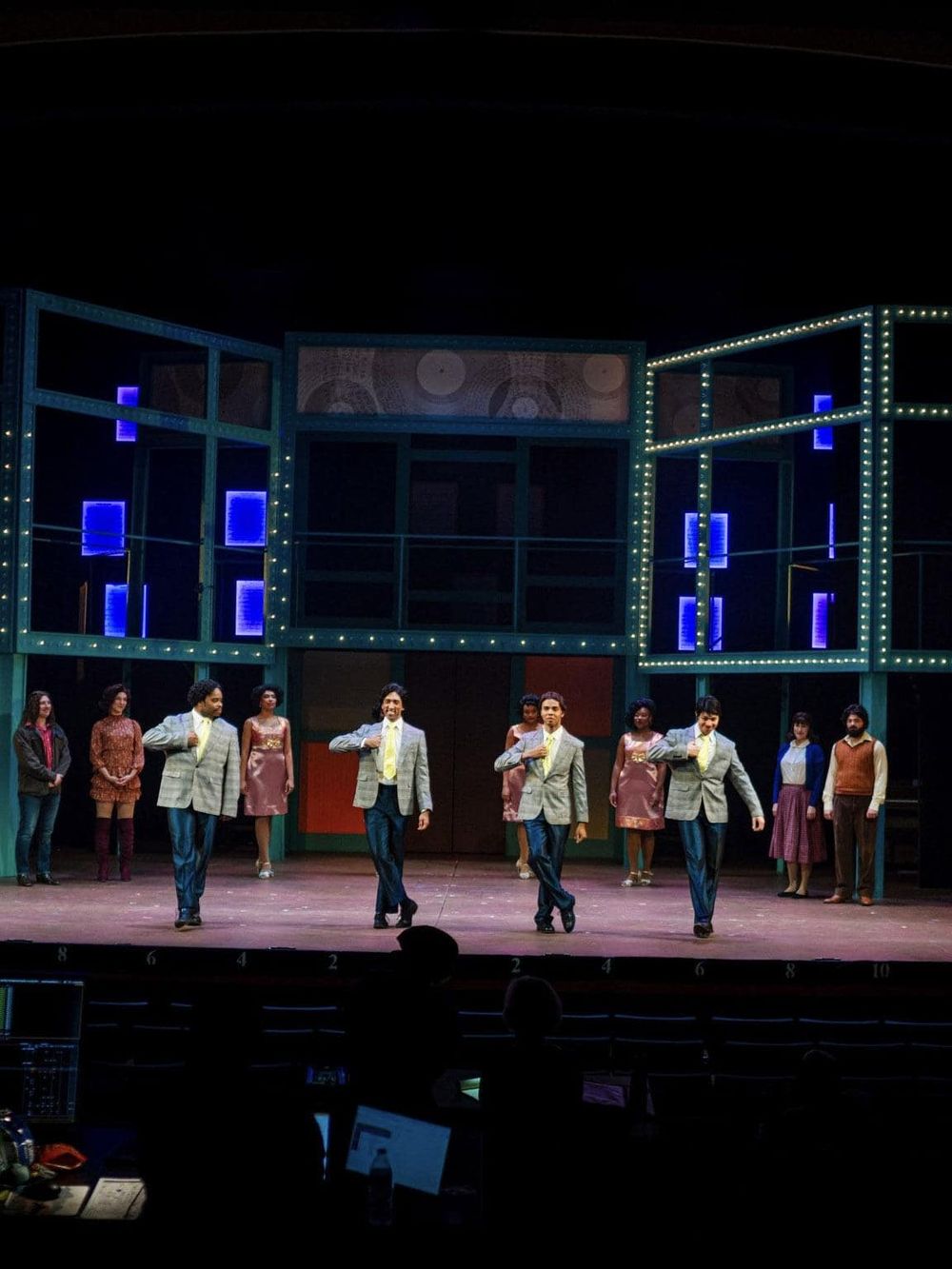 Bright theater stage with performers and vibrant lighting, showcasing performing arts and theatrical entertainment.