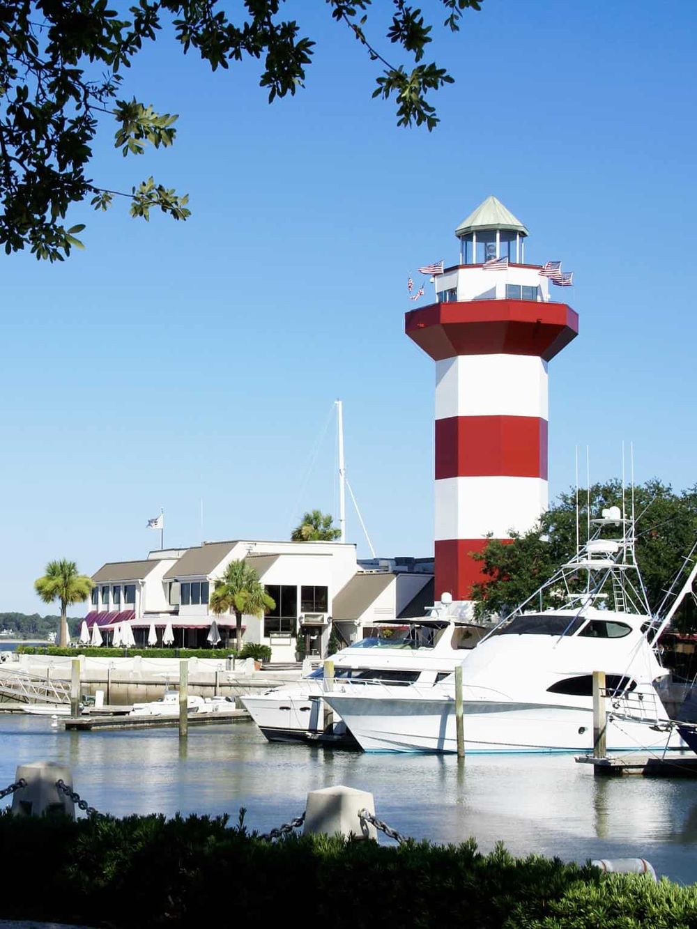 Lighthouse at marina in Jacksonville, Florida, with boats and clear blue sky.