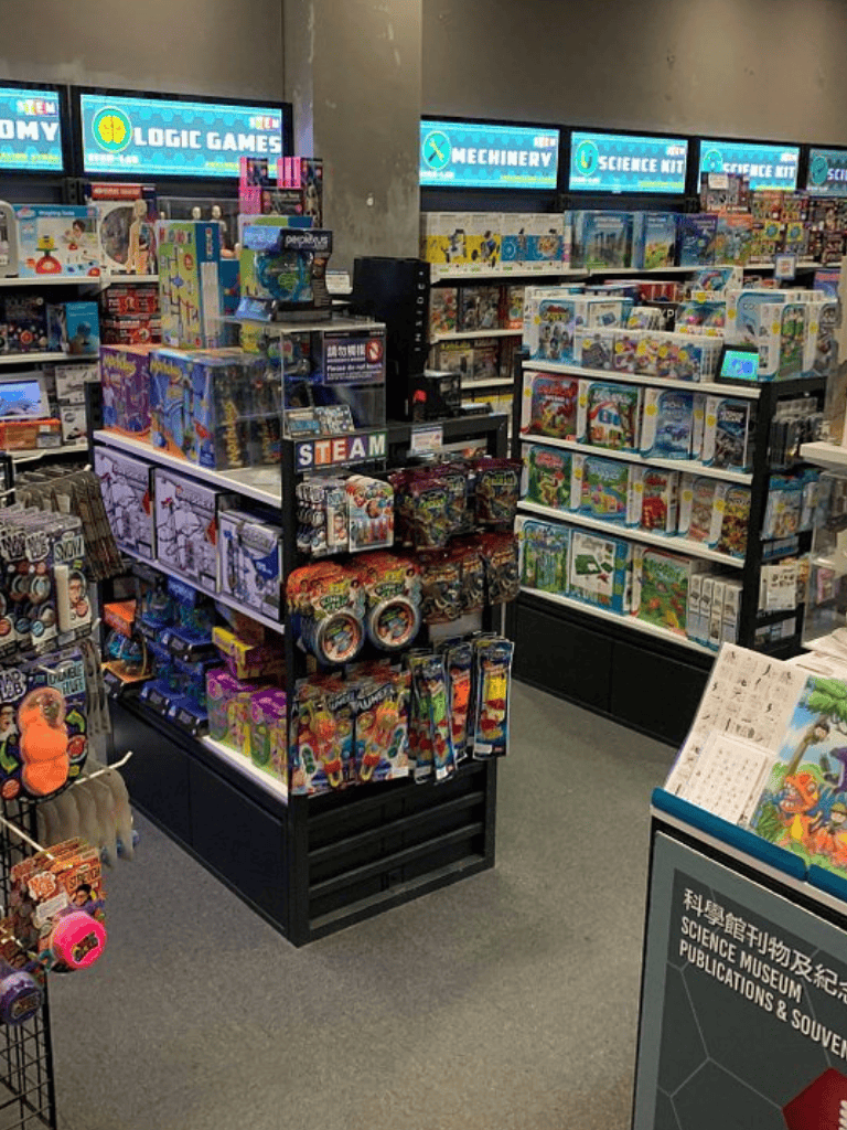 1. Wide-angle view of toy and game shelves at Quest For Directions store.