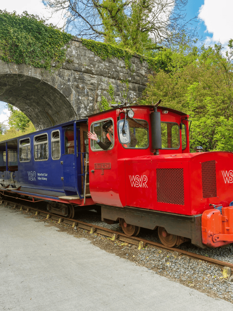 Vintage train ride at Waterford Surrey Valley Railway in scenic outdoor setting.