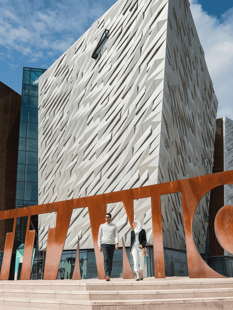 Modern architecture building with QuestForDirections signage, urban scene, escalators, NYCInspired.