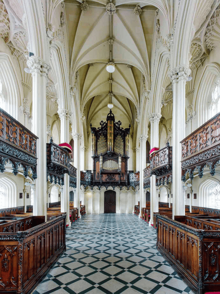 Ornate Gothic church interior with high vaulted ceilings and intricate woodwork, classic architecture.