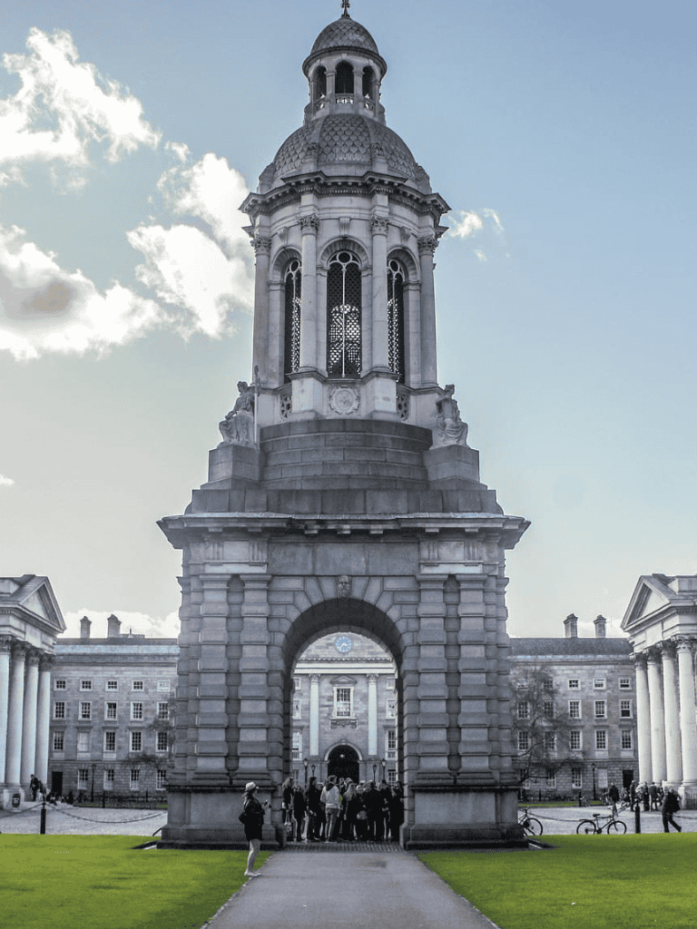 Bell tower at Trinity College Dublin overlooking historic campus and visitors, featuring classic architecture.