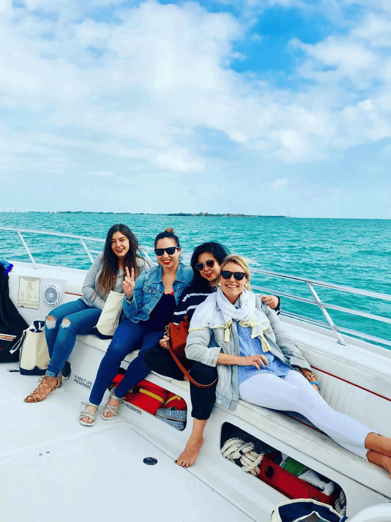 Happy women enjoying a boat ride on the open sea, perfect for adventure and travel enthusiasts.