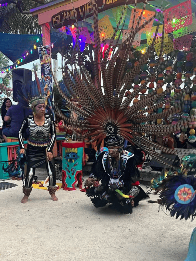 Vibrant Mexican cultural dancers in traditional costumes at Isla Vista festival event.