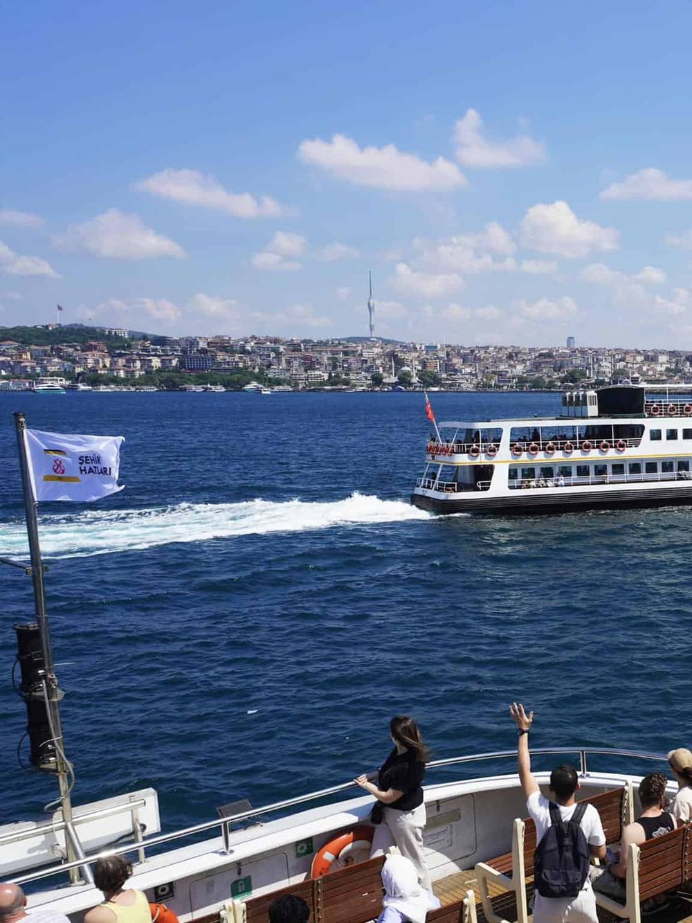 Ferry boat on water with city skyline in background, Istanbul Bosphorus cruise, scenic maritime transportation, travel, tourism, and navigation.