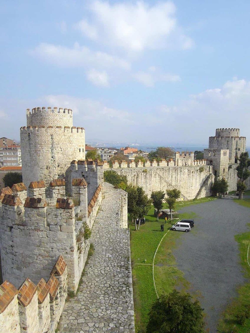 Medieval castle fortress with stone walls and towers, historic landmark for tourist exploration.