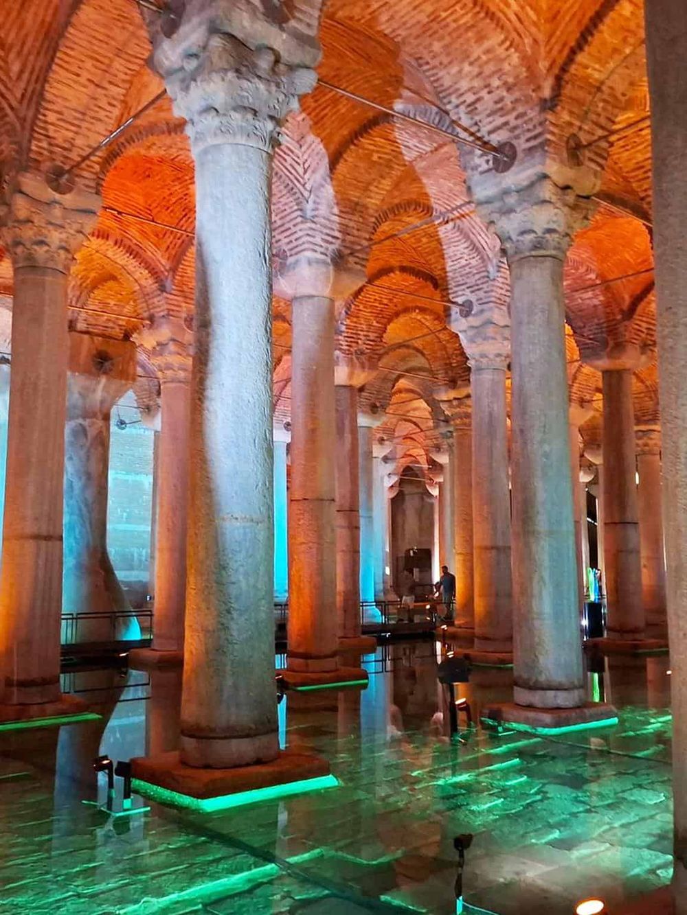 Ancient Roman water cisterns with illuminated arches, showcasing historical architecture and impressive underground structures.