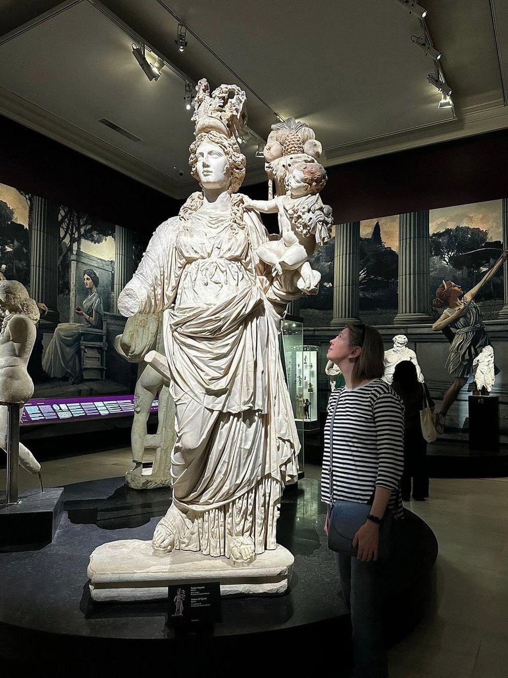 Ancient Greek statue in a museum showcasing classical sculptures and artifacts.