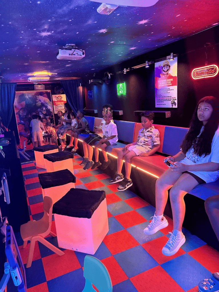 Kids' arcade gaming zone with neon lights and colorful decor for children’s entertainment and fun.