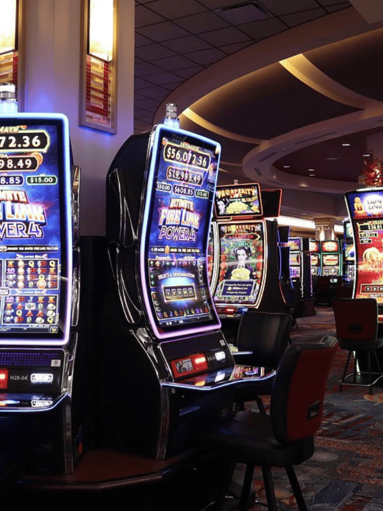 Bright casino slot machines in a lively gaming environment with colorful displays and vibrant lighting.
