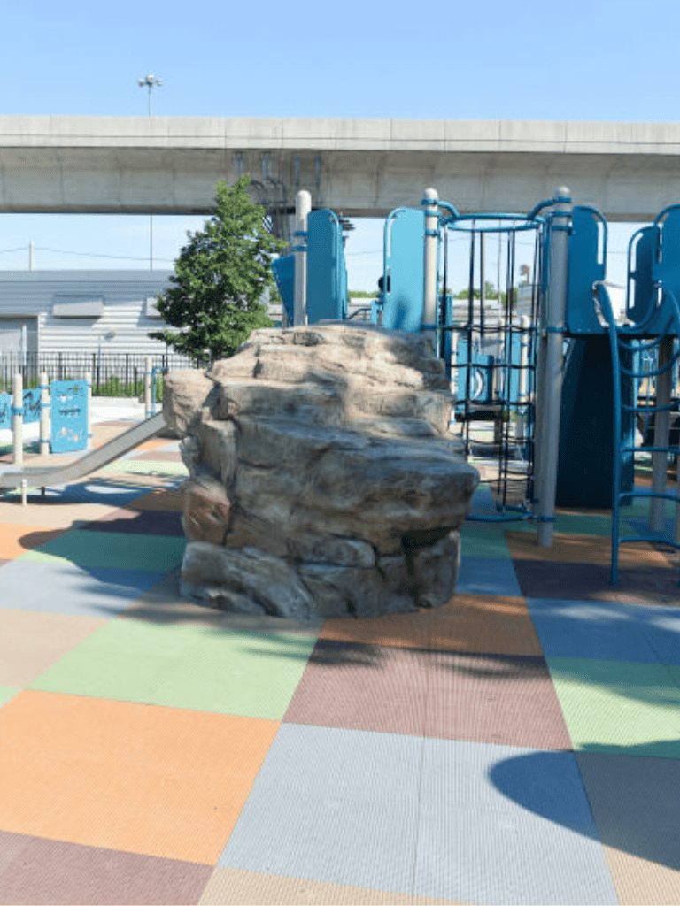 Vibrant playground with rock climbing Adventure structure in bright outdoor park environment.