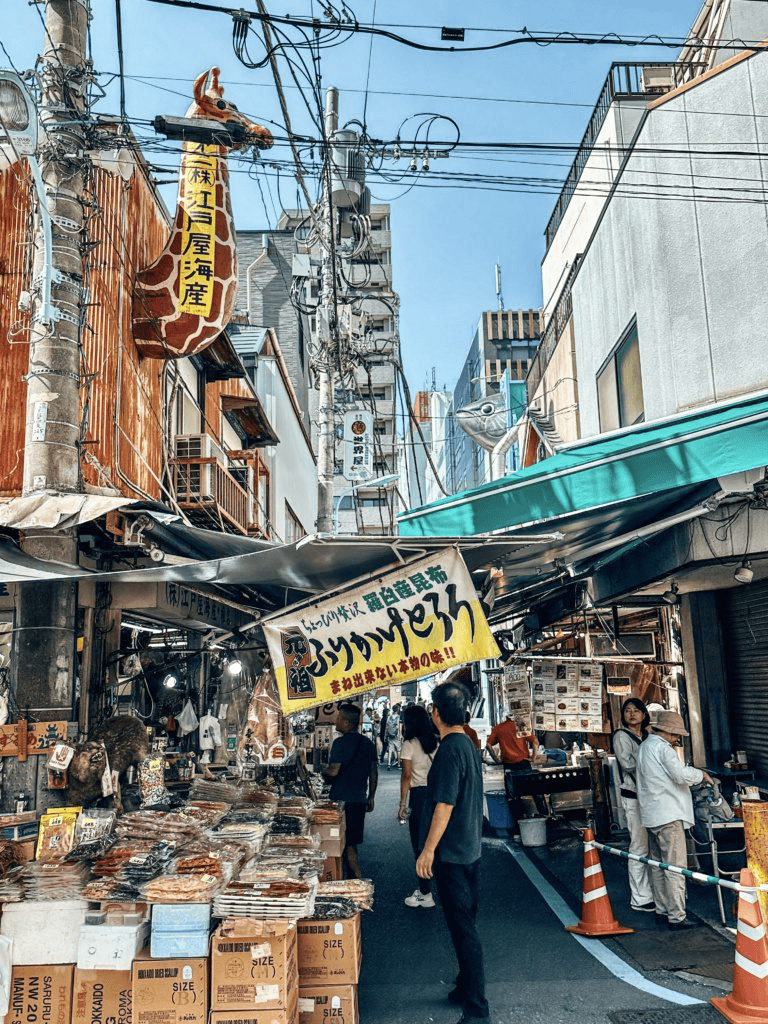 Fresh seafood market in a busy Asian street with old shops and vibrant street life.