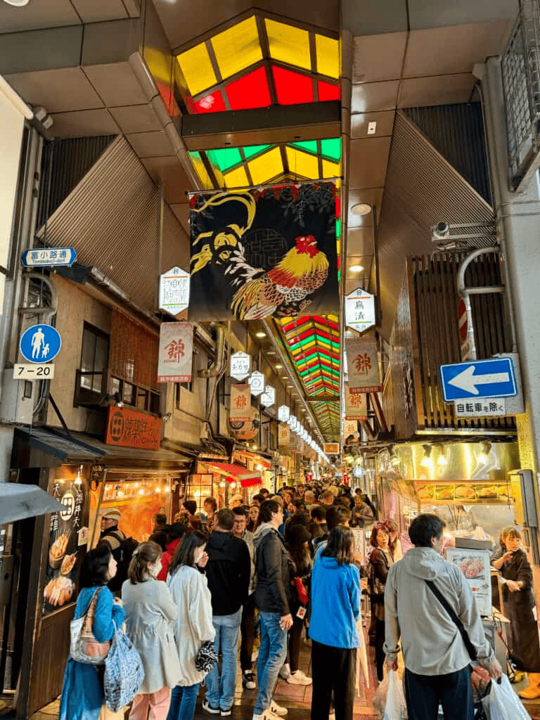 Delimited_image_alt_text: Vibrant illuminated shopping street with crowded stalls and lanterns in Japan.