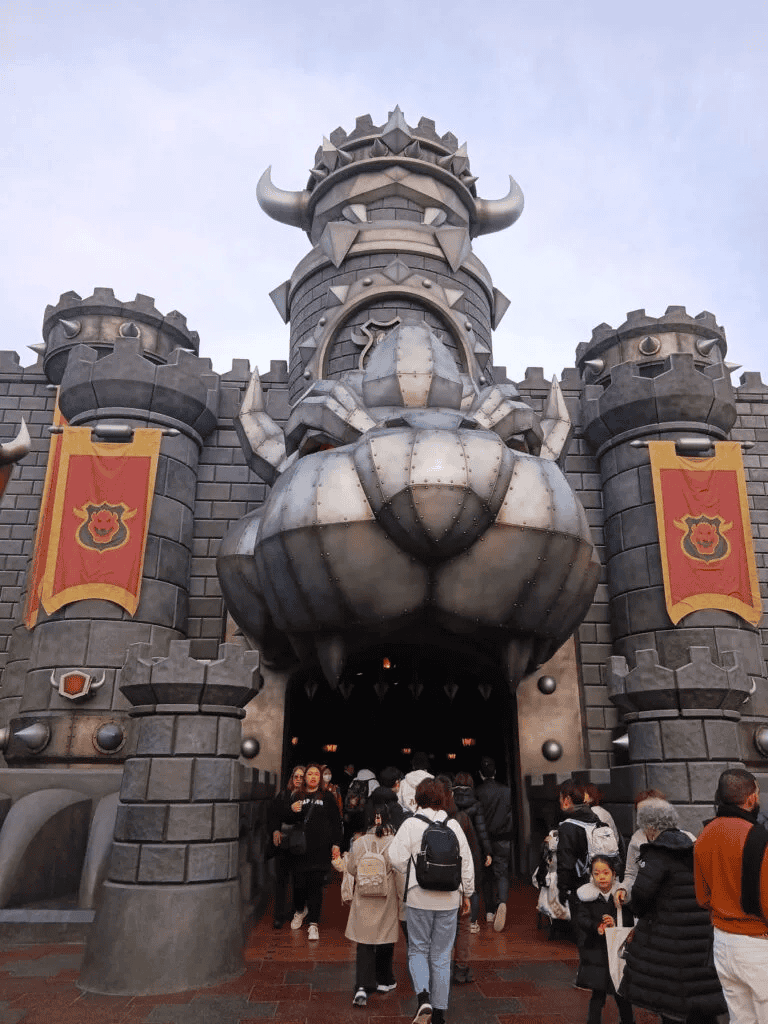 Imposing medieval castle entrance with a dragon head gate at Quest For Directions.