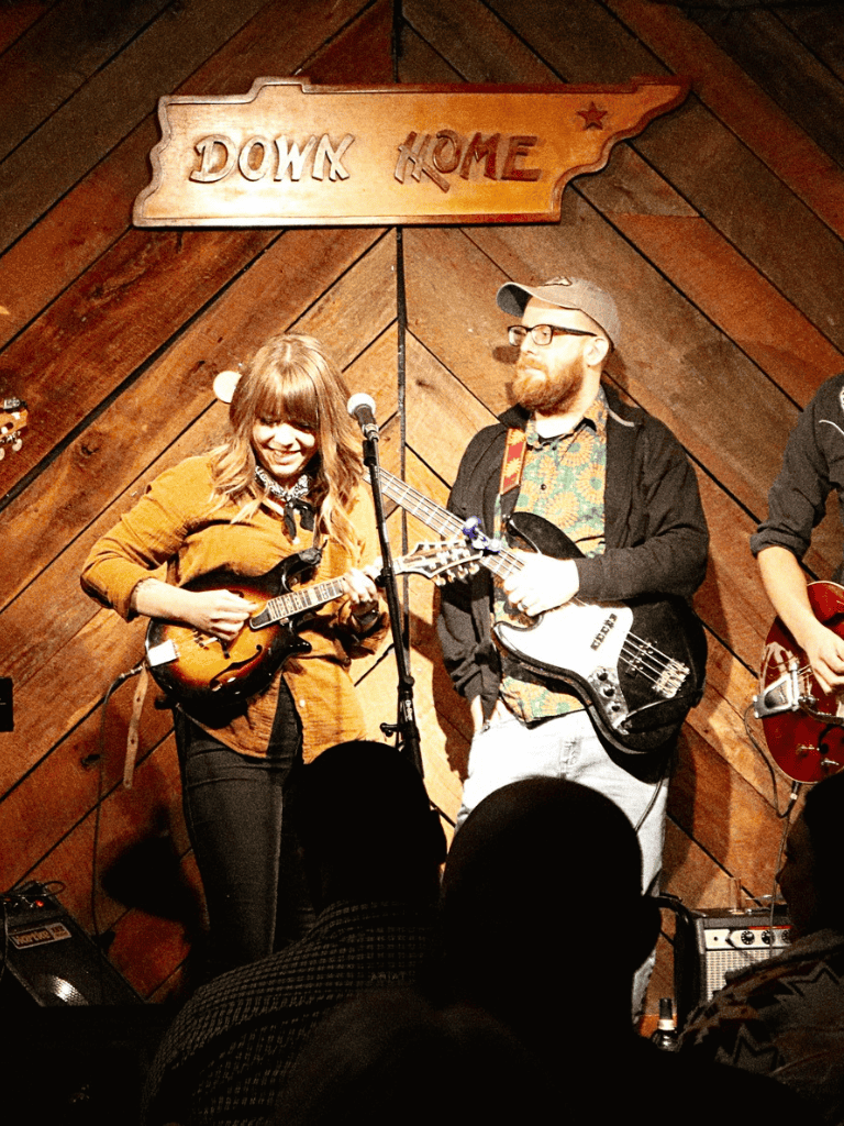 Energetic musicians performing live at QuestForDirections stage, creating a vibrant and engaging musical atmosphere.