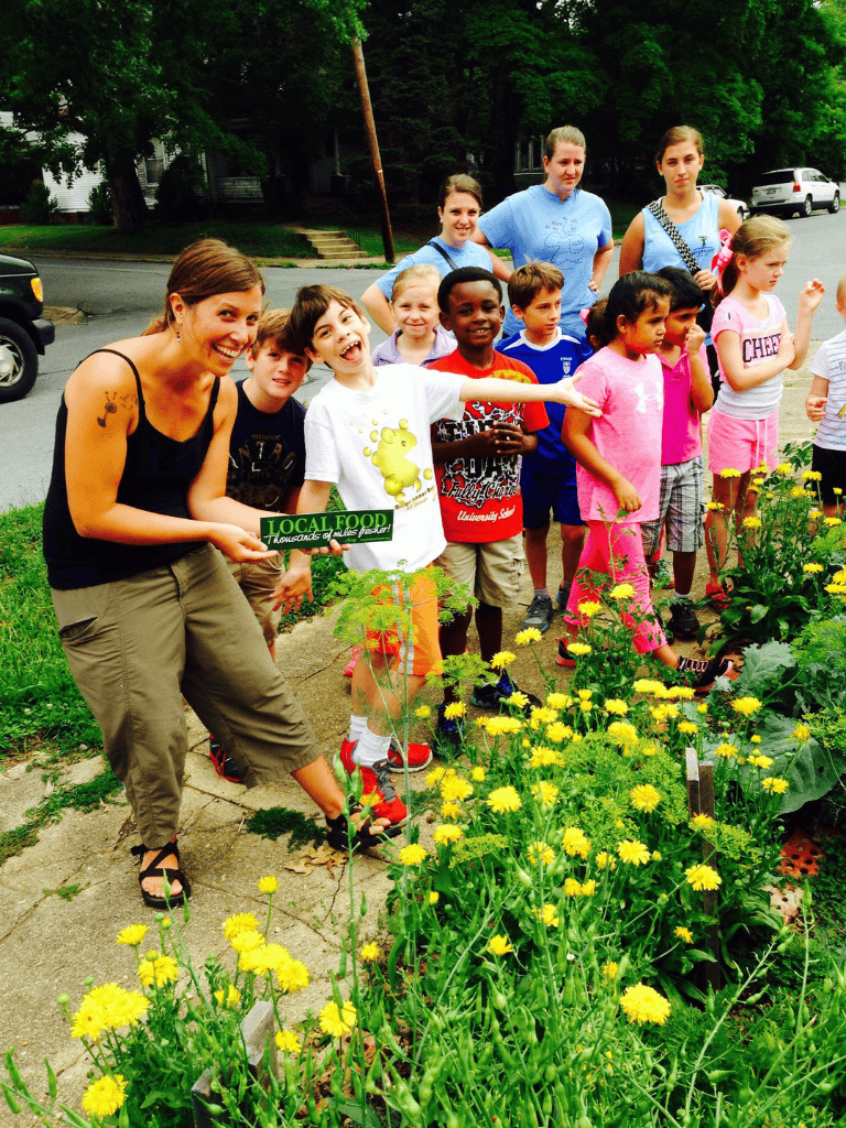 Healthy kids gardening at a community farm garden, promoting local food and sustainability.